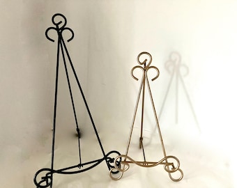 Two iron tripod display stand easels- 17" +12"  for glass, pottery, art 1 gold, 1 black