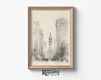 May include: A framed pencil sketch of a city street scene. The artwork depicts tall buildings and a church steeple in the distance. The artwork is in a light brown wooden frame. The bottom of the frame has the text "Retroniva WALL ART".
