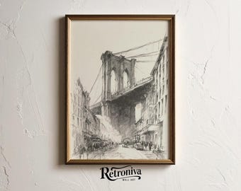May include: A framed black and white pencil sketch of the Brooklyn Bridge, viewed from a city street. The artwork is in a gold-colored frame and features the text "Retroniva Wall Art" at the bottom.