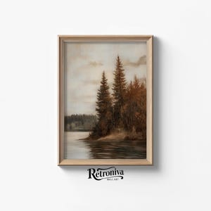 May include: A framed painting of a lake scene with trees on the shore. The trees are a dark green and brown, and the lake is a light blue. The sky is a light blue with some clouds. The painting has a vintage feel.