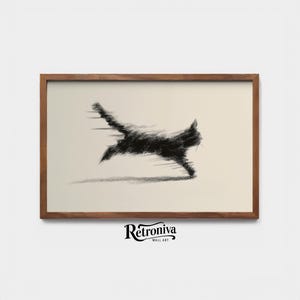 May include: A framed wall art print featuring a black cat in motion, rendered in a sketch-like style. The cat is depicted mid-leap against a cream-colored background. The frame is made of wood. The artwork is branded with the text "Retroniva Wall Art".