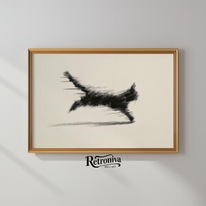 May include: A framed art print featuring a black, sketched image of a running cat with motion blur. The artwork is set against a cream-colored background and framed in a gold-colored frame. The bottom of the frame has the text "Retroniva Wall Art".