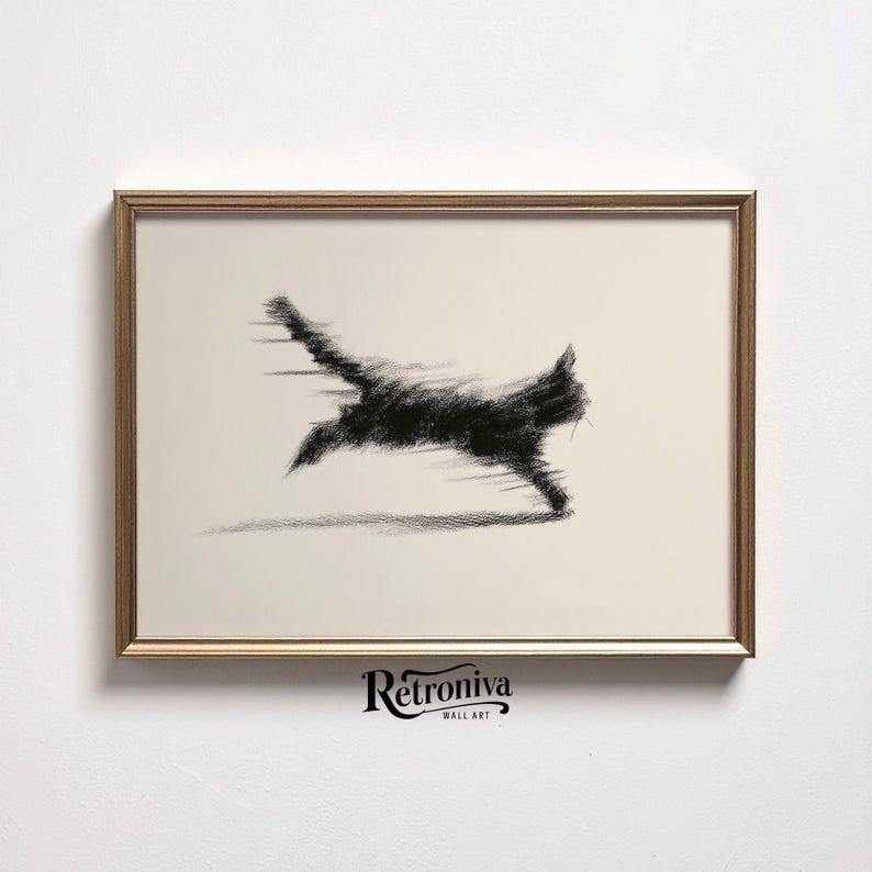 May include: A framed wall art print featuring a black cat in motion, rendered in a charcoal sketch style. The cat's form is blurred, suggesting speed, against a cream-colored background. The frame is gold-toned, and the artwork is labeled "Retroniva Wall Art."