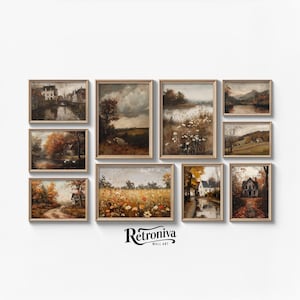 May include: A collection of framed landscape paintings in warm, autumnal tones. The artwork features scenes of houses, rivers, and fields, with a vintage aesthetic. The frames are a light wood color, and the paintings are arranged on a white background.
