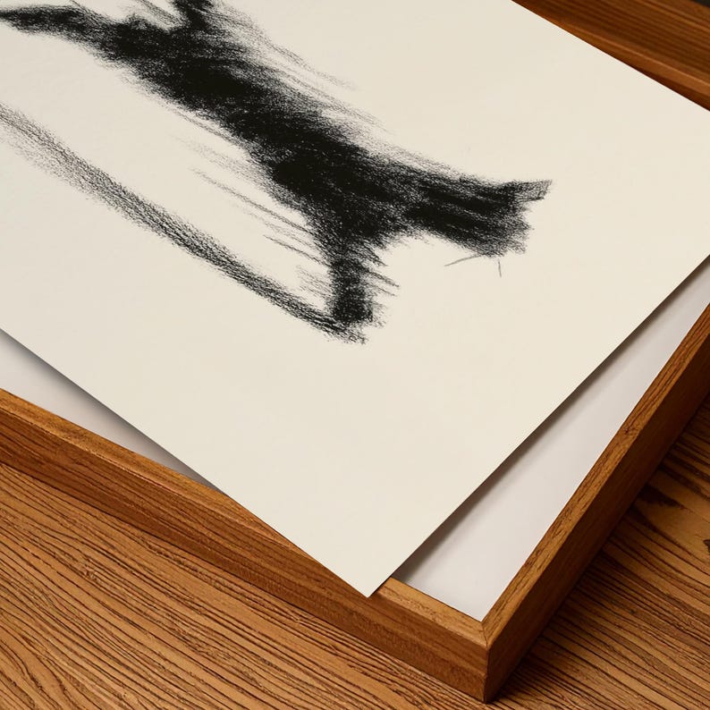 May include: Abstract charcoal drawing on white paper, featuring a bold, textured black stroke. The artwork is presented in a natural wood frame, creating a contrast between the dark art and the light background.