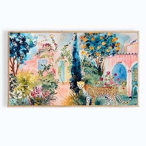 May include: Watercolor painting of a lush garden scene with a cheetah. The artwork features a pink building, blue arched doorways, and vibrant greenery. Orange trees and colorful flowers add to the scene's beauty, framed in a wooden border.
