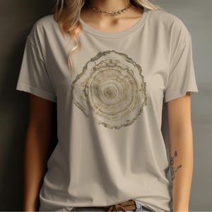 May include: A beige t-shirt with a brown tree ring print.