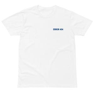 May include: A white t-shirt with the text "ERROR 404" printed in navy blue on the upper left chest area. The shirt is made of a soft material and has short sleeves and a crew neck.