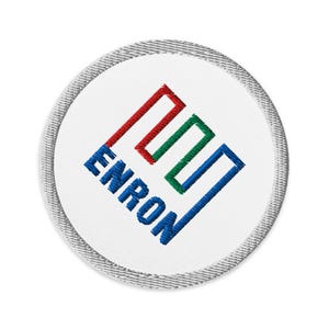 May include: A white round patch with a blue, green, and red logo that says "ENRON" in blue embroidery.