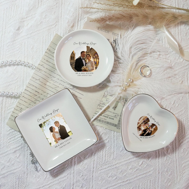 May include: Three white ceramic ring dishes in round, square, and heart shapes. Each dish features a wedding photo and text. The round dish has the text "One Wedding Day" and "MR & MRS WILSON 3rd August 2024". The square dish has the text "MR & MRS TAYLOR 17th May 2016".