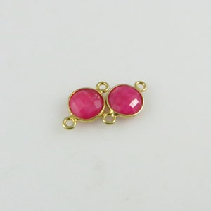 May include: Gold-tone connector with two round pink gemstone accents.