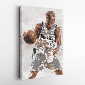 May include: Canvas art print of a basketball player in a Dallas Mavericks uniform, dribbling a basketball. The artwork features a watercolor style with splashes of color and the word "DALLAS" on the jersey.