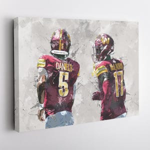 May include: Two football players in maroon and gold uniforms with white numbers. The player on the left is wearing number 5 and the player on the right is wearing number 17. The background is a gray and white abstract design.