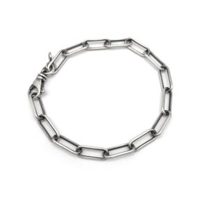 May include: A silver-colored chain link bracelet with a lobster clasp closure. The bracelet features a series of rectangular links connected together. The metal has a slightly aged appearance, giving it a vintage or industrial aesthetic.
