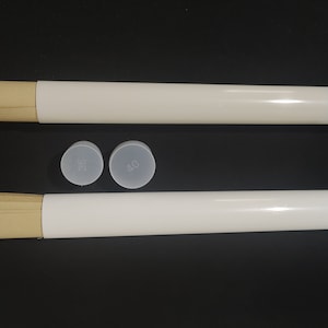 May include: Two white poster tubes with brown paper inserts and clear plastic end caps. The end caps have the numbers 35 and 40 printed on them.