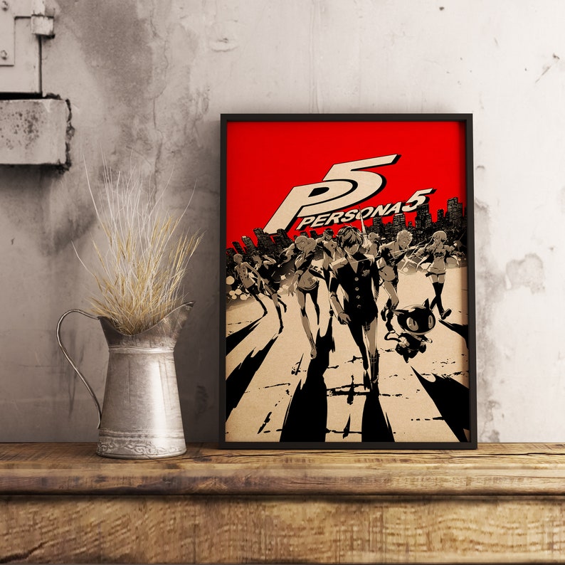 May include: A black framed poster with a red background featuring the text "PERSONA5" and a group of characters in black and white walking on a crosswalk.