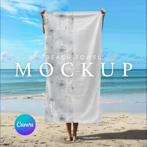 May include: A white beach towel with a dandelion pattern on one side and a plain white side on the other. The towel is held up by a person on a beach with blue water and white sand in the background. The text "Beach Towel Mockup" is written on the towel.