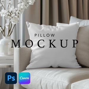 May include: White pillow mockup on a light beige couch with a vase of white flowers in the background. The text "PILLOW MOCKUP" is printed on the pillow.