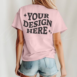 May include: A pink t-shirt with short sleeves and the text "YOUR DESIGN HERE" printed on the back.