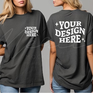 May include: A dark gray oversized t-shirt with short sleeves. The front of the shirt has the text "YOUR DESIGN HERE" in white. The back of the shirt has the text "YOUR DESIGN HERE" in white.