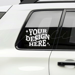 May include: White car with a black window and a white vinyl sticker that says "YOUR DESIGN HERE" with stars on either side.