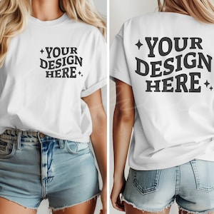 May include: White t-shirt with short sleeves and a crew neck. The front of the shirt has the text "YOUR DESIGN HERE" printed in black. The back of the shirt has the same text printed in black.
