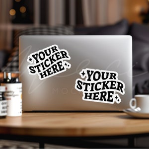 May include: Two white stickers with black text on a silver laptop. The stickers say "Your Sticker Here" with a star on each side of the text.