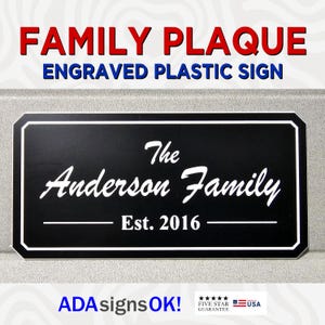May include: Black engraved plastic plaque with white lettering that reads "The Anderson Family Est. 2016".