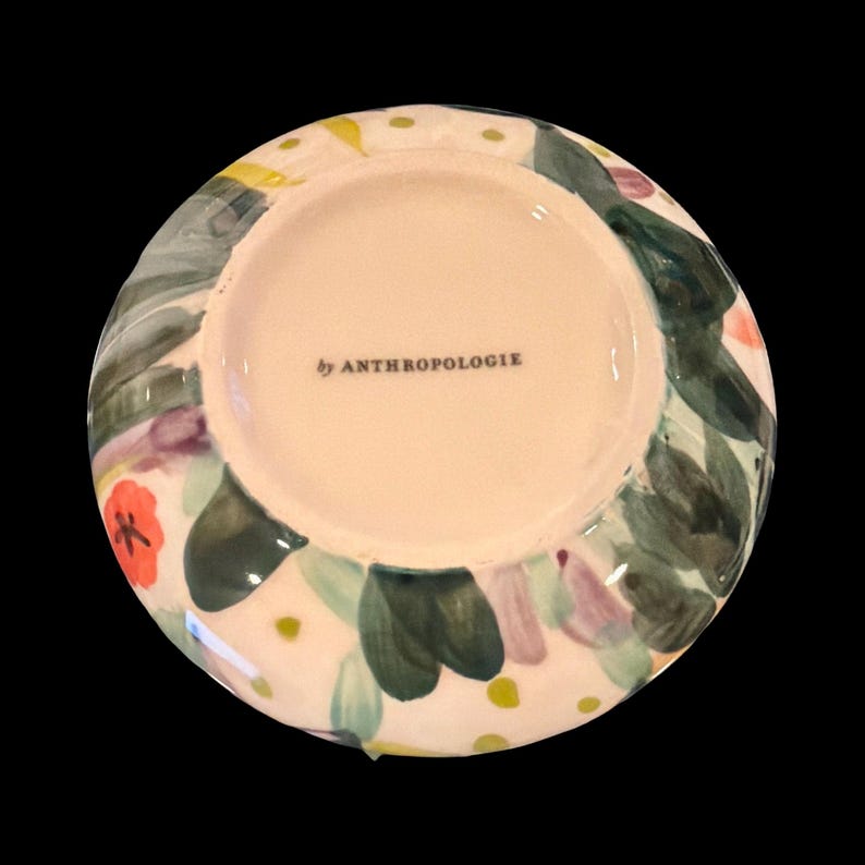 May include: A white ceramic mug with a black handle and the text "But First, Coffee" in a black, bold font. The mug is on a white surface. The mug is 4 inches tall.