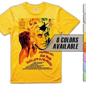 May include: Yellow t-shirt featuring a vintage movie poster design with a vampire and a woman. The poster text reads "Pardon me, But Your Teeth are in My Neck".