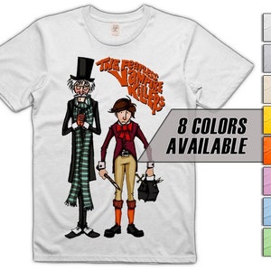 May include: White t-shirt featuring a graphic of two men in Victorian attire. The text "The Fearless Vampire Killers" is printed in orange on the shirt.