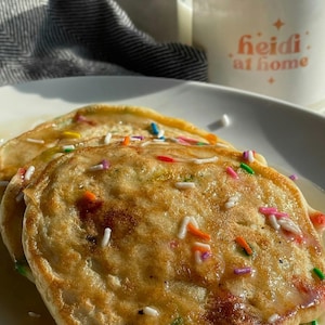 Pu&ograve; includere: Due pancake dorati ricoperti di codette bianche e colorate e un filo di sciroppo.