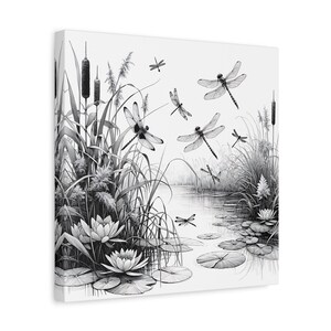 May include: Black and white canvas art print of a serene pond scene. Dragonflies are depicted in flight above water lilies, reeds, and cattails. The artwork has a detailed, illustrative style, creating a tranquil nature theme.