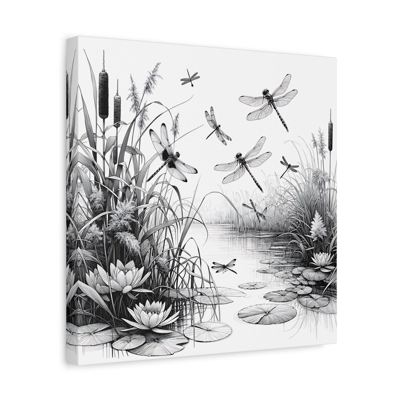 May include: Black and white canvas art print of a serene pond scene. Dragonflies are depicted in flight above water lilies, reeds, and cattails. The artwork has a detailed, illustrative style, creating a tranquil nature theme.