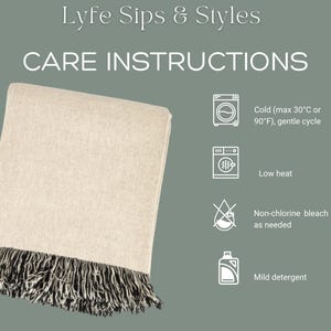 May include: A folded beige blanket with black and white fringe. The image includes care instructions: cold wash (max 30&deg;C or 90&deg;F), low heat, non-chlorine bleach as needed, and mild detergent. The text "Lyfe Sips & Styles" is at the top.