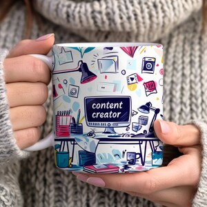 May include: White ceramic mug with a colorful design featuring a computer screen with the text "content creator" and other office supplies.