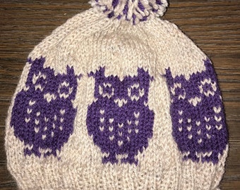 May include: Knitted hat with a pom pom on top. The hat is beige with a purple owl design. The text "Pattern Only" is visible in the image.