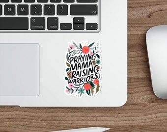 May include: A white sticker with a floral design and the text "Praying Mama Raising Warriors".