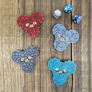 May include: Four wooden tri-cornered dice trays with different designs. The trays are blue, grey, red, and teal. Each tray has a different pattern and the numbers 0, 2, 4, 6, and 8 printed on them.