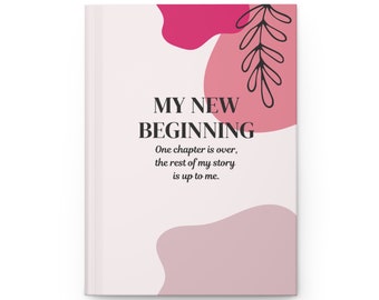 May include: A pink and white journal cover with abstract shapes and a leafy branch design. The text on the cover reads "MY NEW BEGINNING. One chapter is over, the rest of my story is up to me."