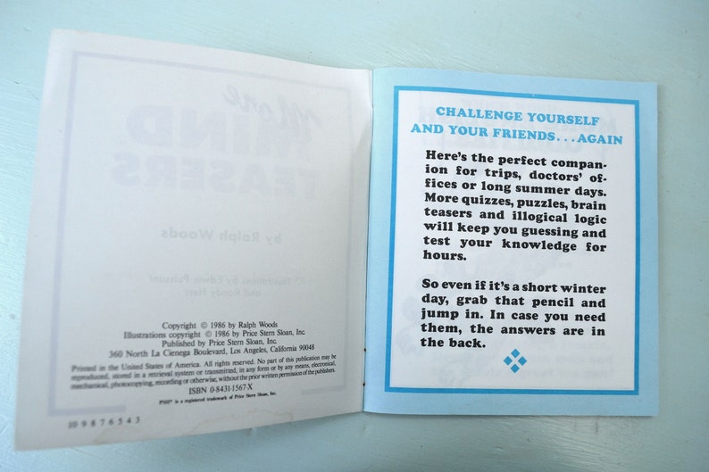 May include: A blue and white book with the title "Challenge Yourself and Your Friends...Again". The book is open to a page with text about the book's contents. The text includes the copyright information for the book.