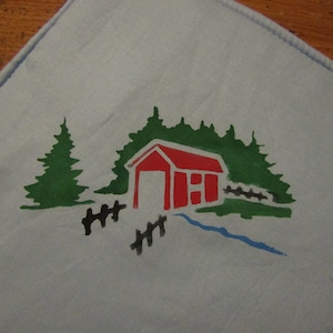 May include: A red wooden bridge painted on a blue fabric with green trees and a black fence on either side.