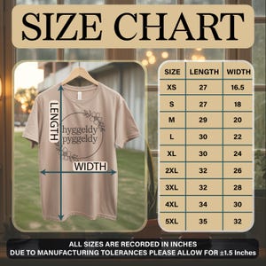 May include: A beige t-shirt with the words "hyggeldy pyggeldy" within a floral wreath. The image features a size chart with measurements in inches for sizes XS, S, M, L, XL, 2XL, 3XL, 4XL, and 5XL. The chart shows length and width.