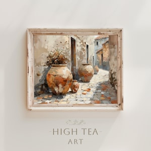 May include: A painting depicting a narrow, cobbled street in a European village. The street is lined with old buildings and there are three large terracotta pots with plants growing out of them. The painting is framed in a white frame with a distressed finish.