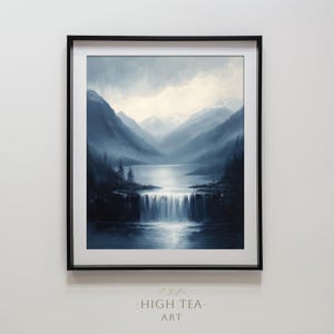 May include: A framed painting of a blue and white landscape with a waterfall. The painting depicts a mountain range with a lake in the foreground and a waterfall cascading down a rocky cliff. The sky is a light blue with white clouds.