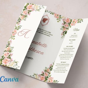 Puede incluir: Una invitación plegada en tres pliegues con un diseño floral. El panel frontal presenta una gran letra "A" en una fuente de escritura rosa. Los paneles interiores presentan un diseño floral con el texto "El mayor placer es asegurarle que le invitamos a asistir a una celebración en honor a Annabelle Hutheson". El panel posterior presenta un menú con el texto "Menú" y una lista de alimentos.