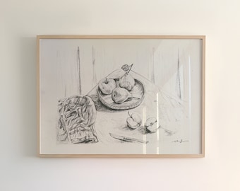 May include: A white kitchen with a wood countertop and cabinets. There is a framed black and white drawing of fruit on the wall above the countertop. There are three ceramic vases and a bowl on the countertop.