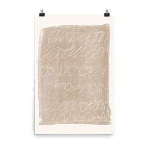 May include: Abstract art print with a beige background and white scribbles. The print has a textured look and a subtle distressed effect.