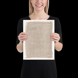 May include: A beige abstract print with white lines. The print is on a white background and is framed.