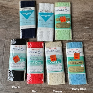 May include: Assortment of wide stretch lace trim in various colors, including black, red, cream, and baby blue. Each spool features a label with the brand name "Wright's", the lace type, and the price. The lace is 1 inch wide and 2 1/2 yards long.